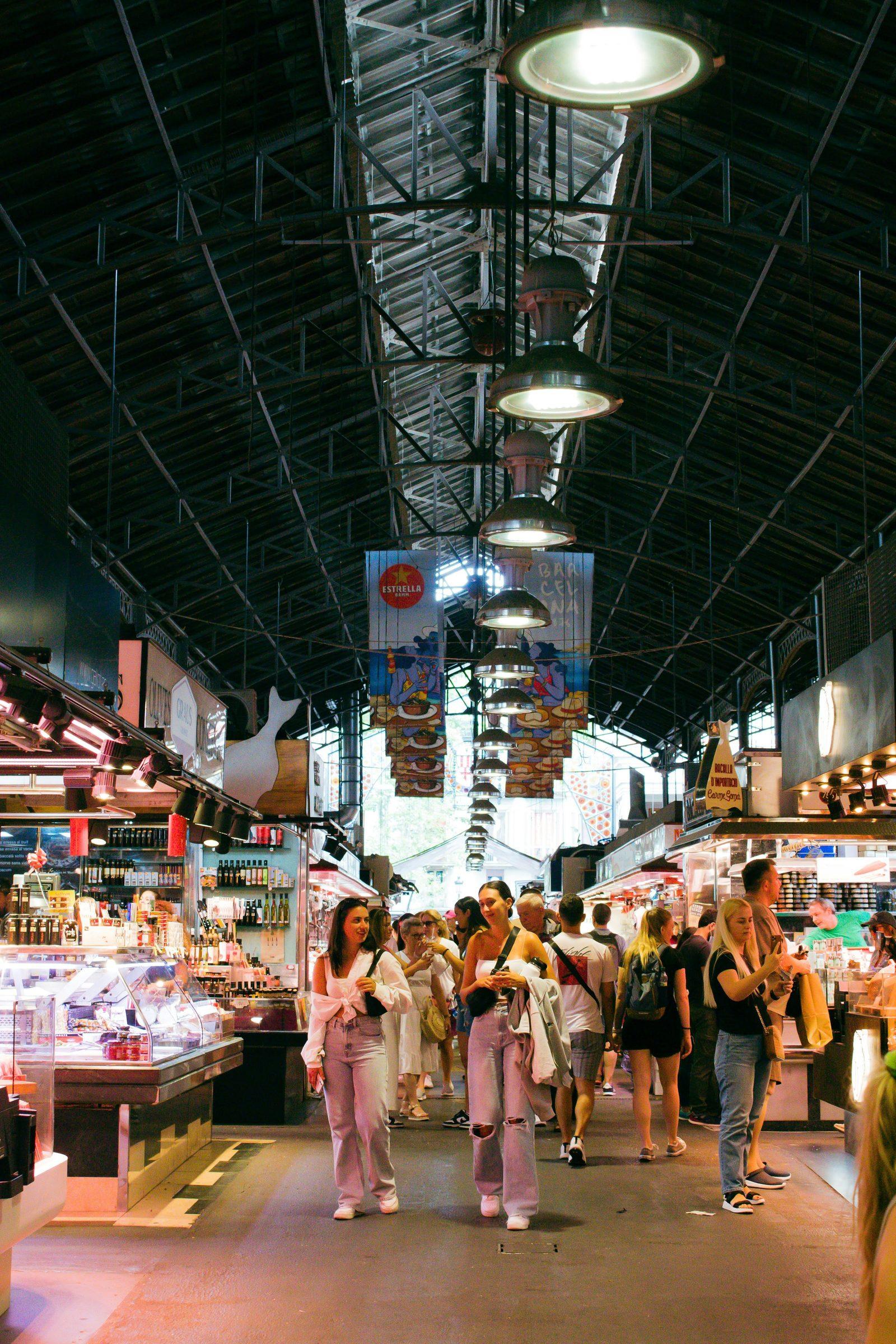 La Boqueria market interior in Barcelona with hanging lights and food stalls