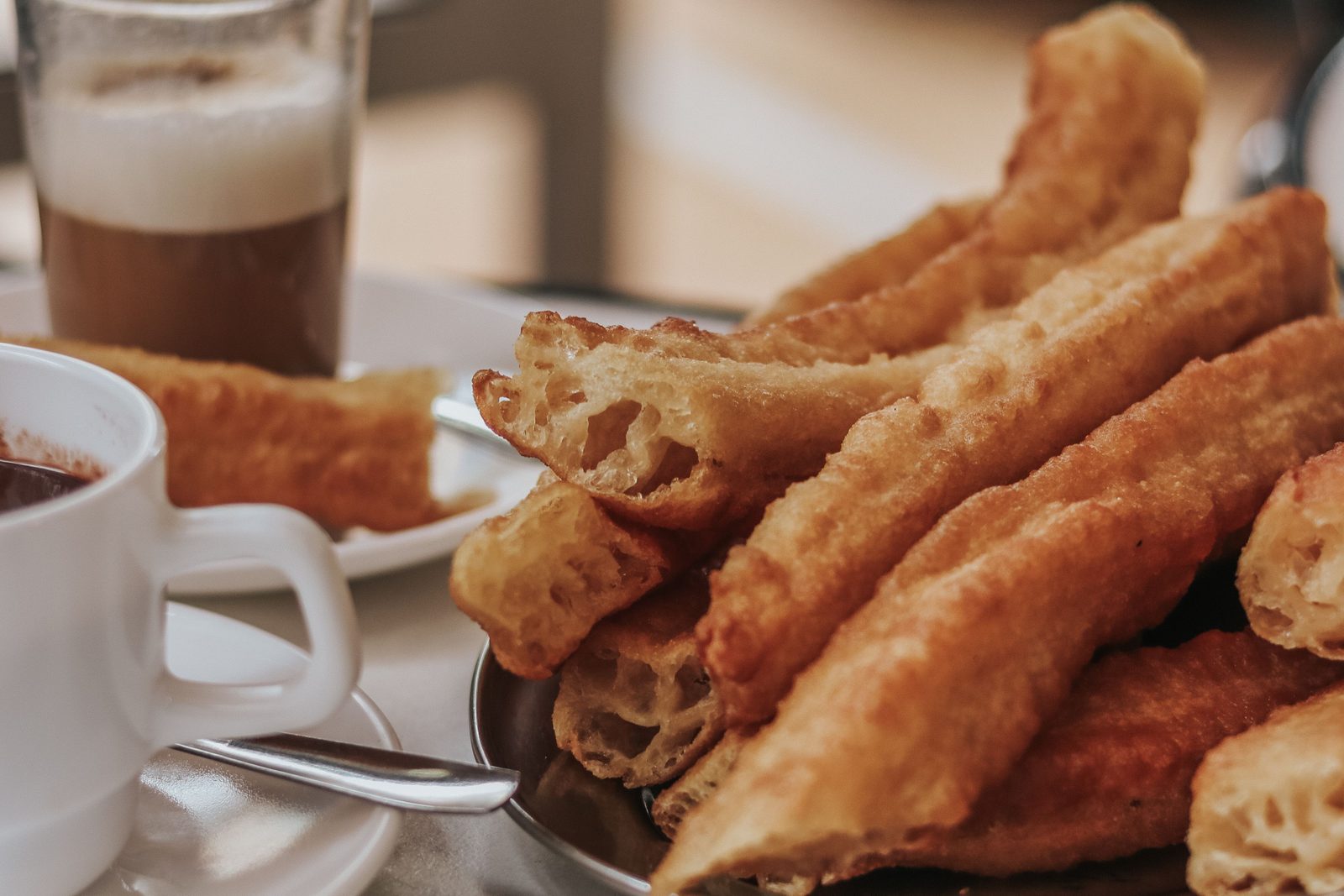 Porras and hot chocolate with a café con leche in Madrid