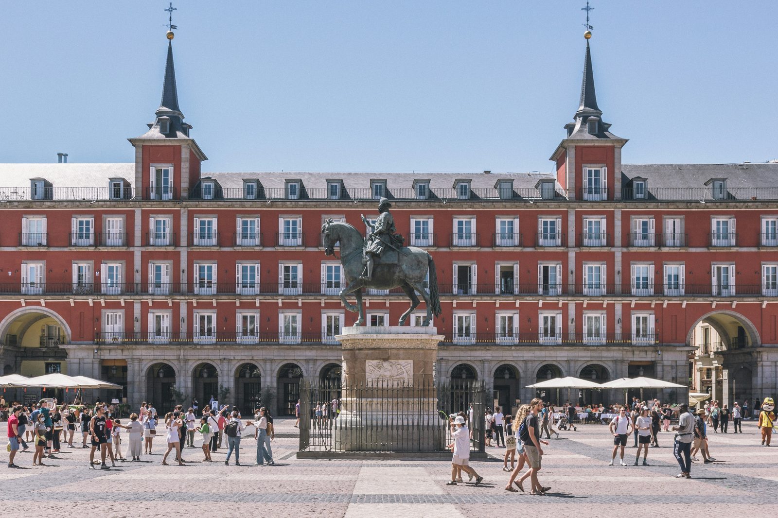 Plaza Mayor in Madrid with terracotta buildings and equestrian statue