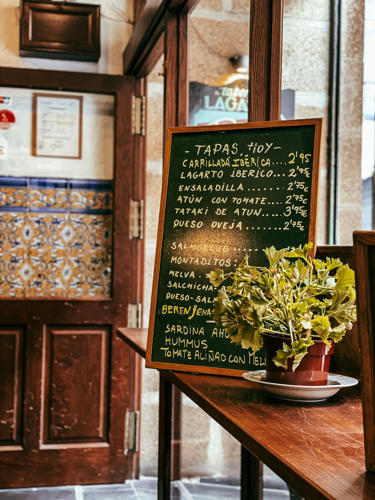 Handwritten Spanish tapas menu on a chalkboard at a traditional bar in Spain