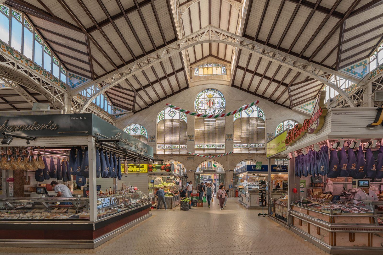 Ham stalls and stained glass inside the Mercado Central in Valencia